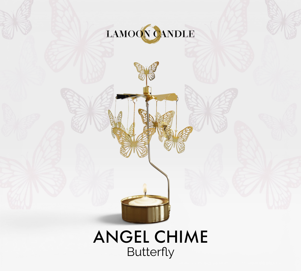 Golden butterfly charms hanging on a spinning thermal carousel tealight candle holder