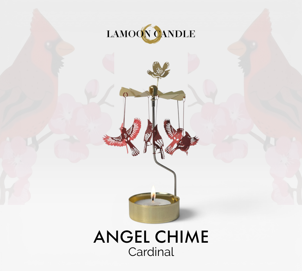 Kinetic gold candle holder featuring red cardinal bird charms spinning around a tealight flame