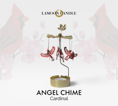 Kinetic gold candle holder featuring red cardinal bird charms spinning around a tealight flame