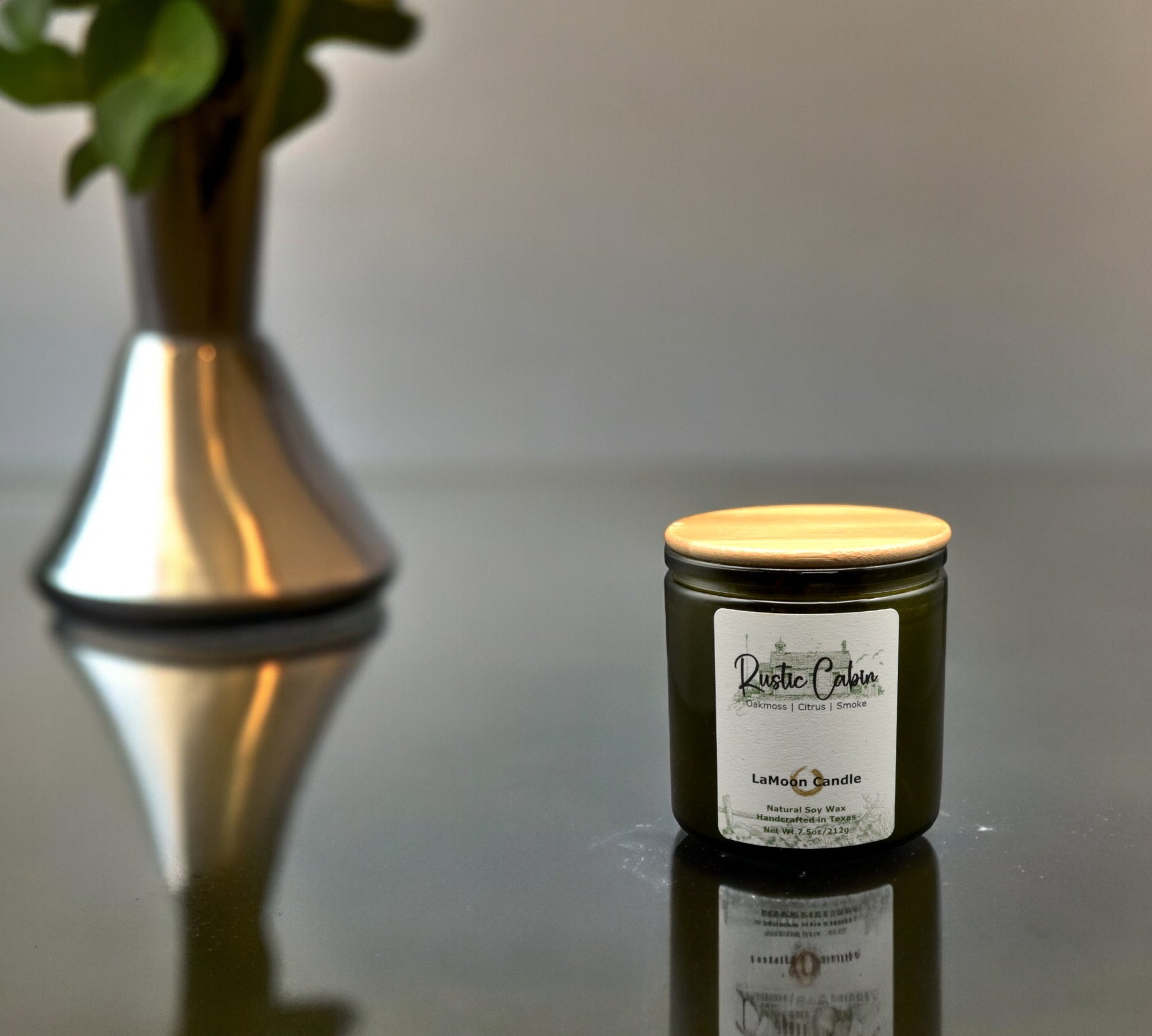 Natural soy wax candle in vintage green glass container and bamboo lid.