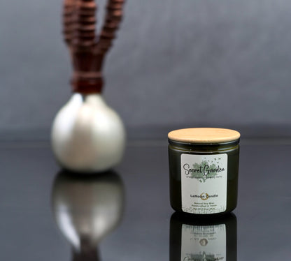 Natural soy wax candle in vintage green glass container and bamboo lid.