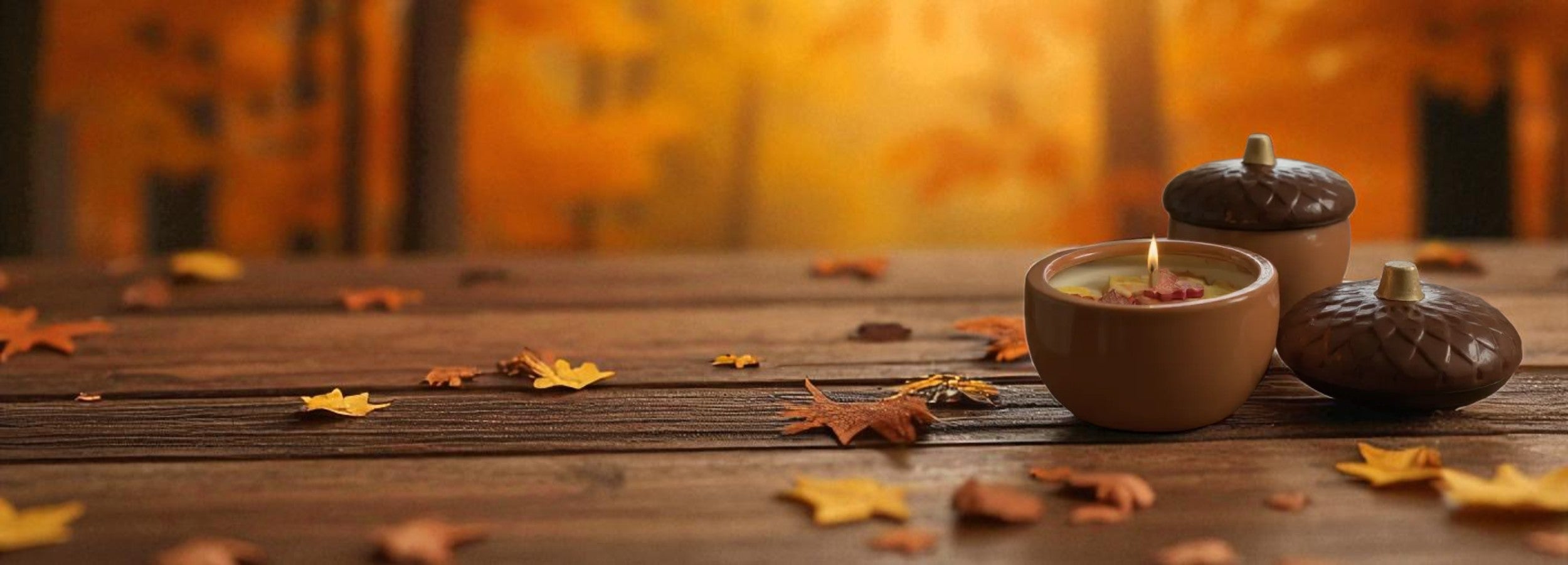 Soy Wax Candle in a Acorn-shaped ceramic jar with autumn leaves and acorns on a wooden surface. LaMoon Candle.