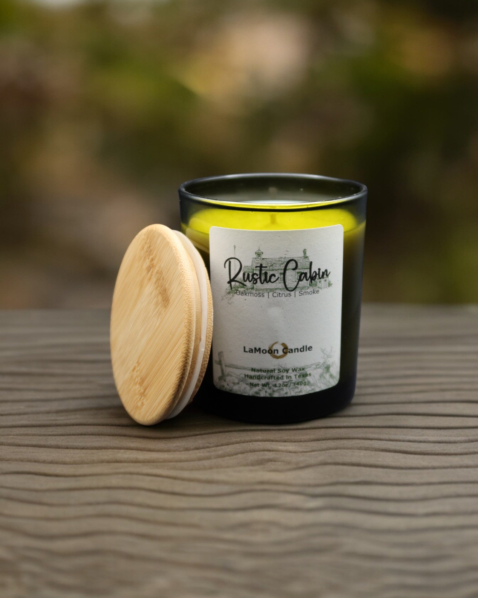 Natural soy wax candle in vintage green glass container and bamboo lid.
