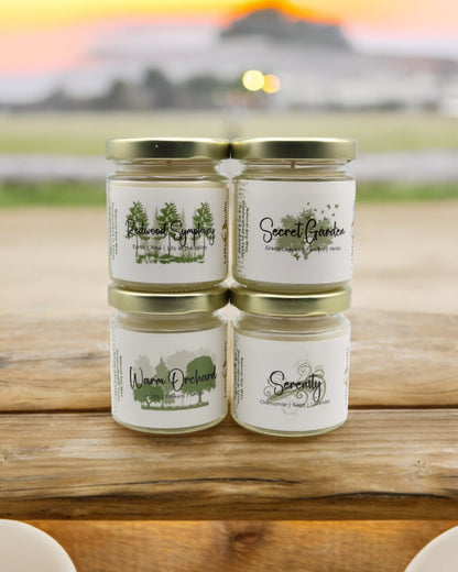 Natural soy wax candle in clear glass container and twist gold lid.