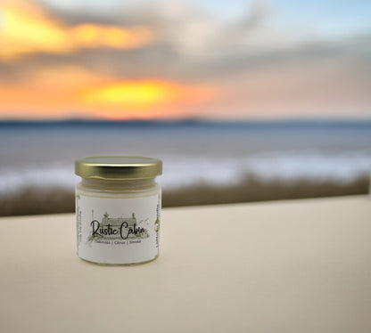 Natural soy wax candle in clear glass container and twist gold lid.