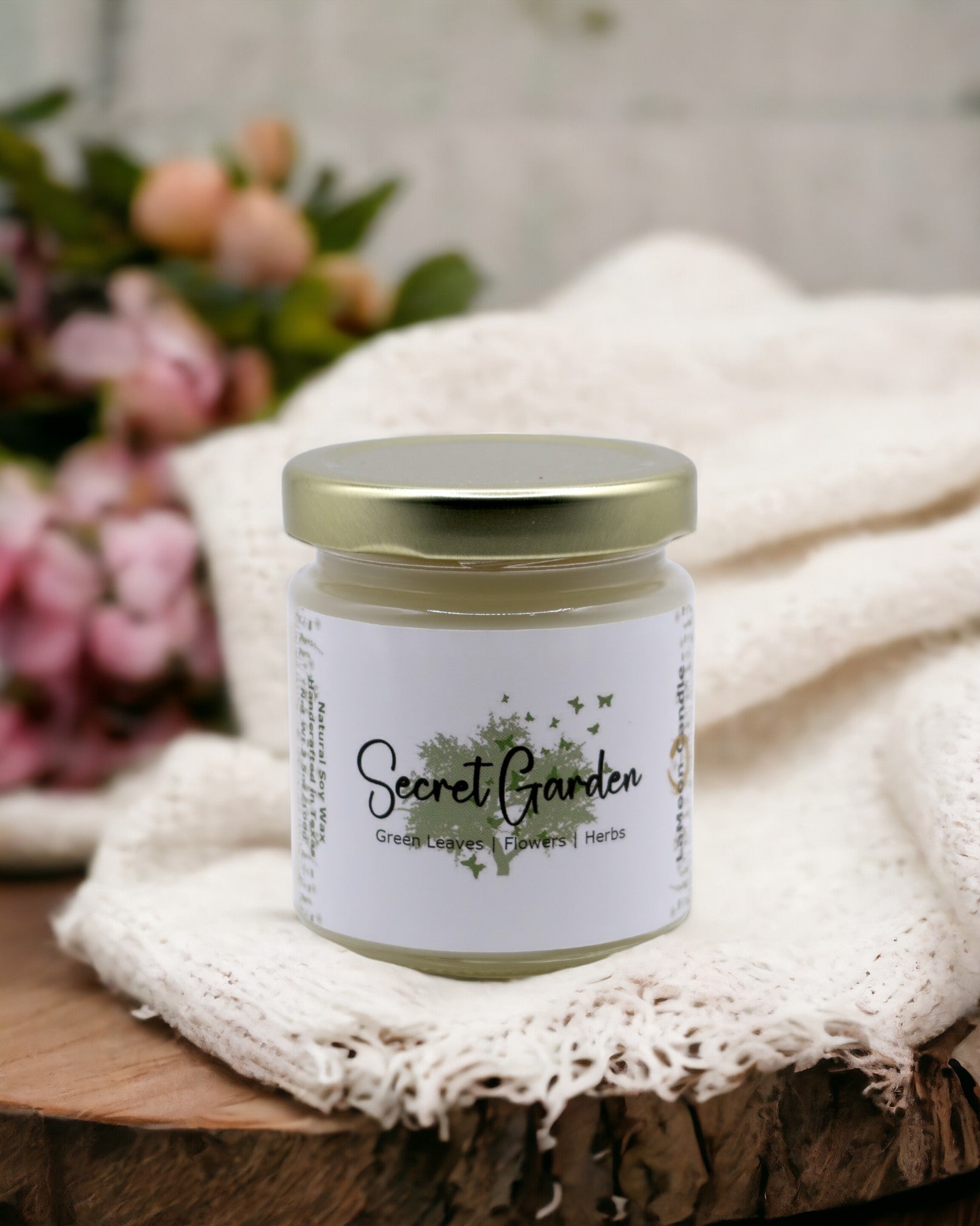 Natural soy wax candle in clear glass container and twist gold lid.