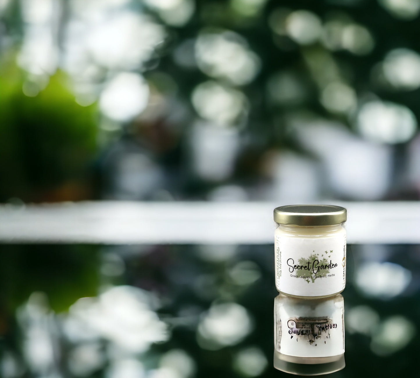 Natural soy wax candle in clear glass container and twist gold lid.