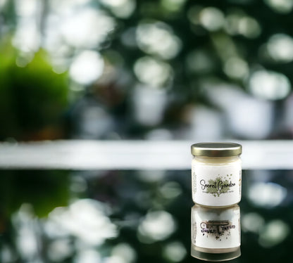 Natural soy wax candle in clear glass container and twist gold lid.