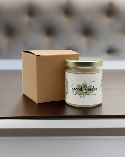 Natural soy wax candle in clear glass container and twist gold lid.