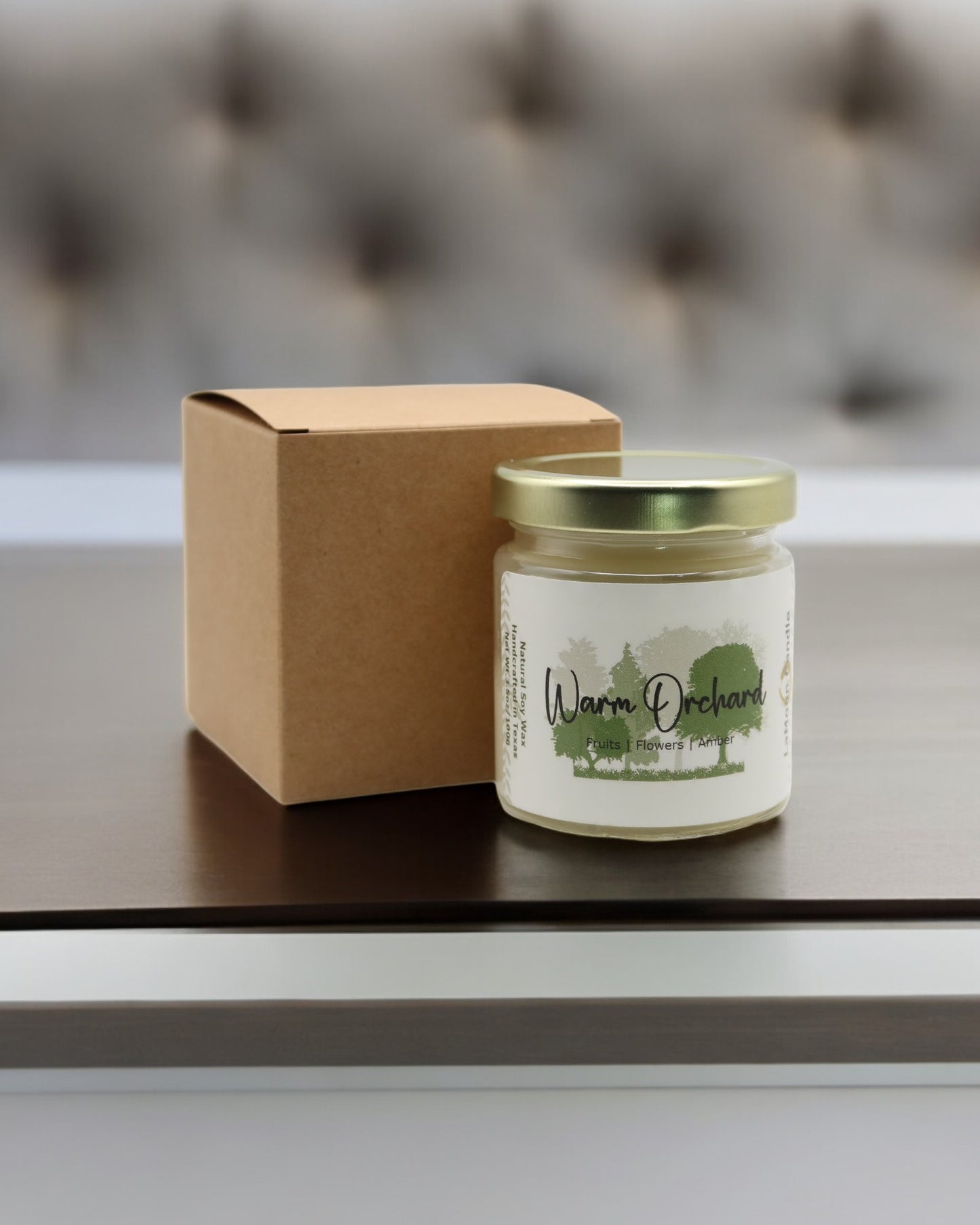 Natural soy wax candle in clear glass container and twist gold lid.