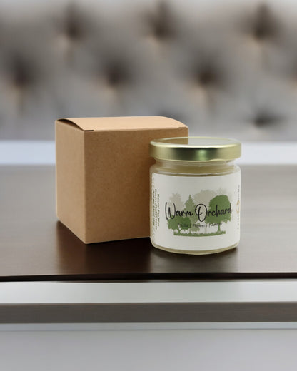 Natural soy wax candle in clear glass container and twist gold lid.